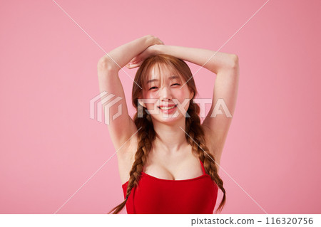 Korean woman in her 20s posing in a monokini look with a pink background Korean woman in her 20s posing in a monokini look with a pink background 116320756