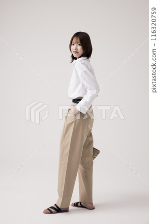 Side view of a Korean woman with her hands in her pants pocket 116320759