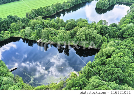 Aerial Oblique View of Dark Fishing Ponds Built from Former Sand Extraction Pits Aerial Oblique View of Dark Fishing Ponds Built from Former Sand Extraction Pits 116321031