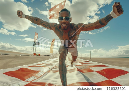 A runner crosses the finish line with arms raised in victory, his face beaming with joy. 116322801