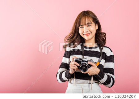Attractive energetic happy Asian portrait beautiful cute young woman teen excited smiling holding vintage photo camera, studio shot isolated on pink background, traveler female photographer Attractive energetic happy Asian portrait beautiful cute young woman teen excited smiling holding vintage photo camera, studio shot isolated on pink background, traveler female photographer 116324207