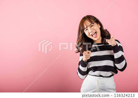 Woman excited smiling makes finger two gun gesture to camera isolated pink background, Happy Asian portrait beautiful young female says you are chosen ll kill you or what up man with cheeky copy space Woman excited smiling makes finger two gun gesture to camera isolated pink background, Happy Asian portrait beautiful young female says you are chosen ll kill you or what up man with cheeky copy space 116324213