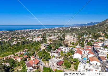 Bellapais Abbey overlooking Kyrenia city with mediterranean sea. Cyprus 116324415