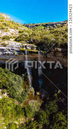 Water cascading down rocky cliff creating scenic Waterfall of Prasteio Avdimou. Limassol District, Cyprus 116324423