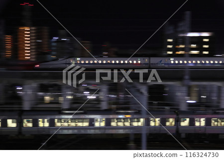 Sanyo Shinkansen and JR Kobe Line Special Rapid Service trains running through Himeji city late at night Sanyo Shinkansen and JR Kobe Line Special Rapid Service trains running through Himeji city late at night 116324730