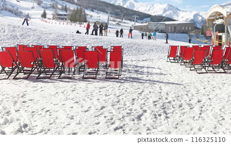 Ski resort in Alps of France. Red chairs outside on sunny day in winter. Holidays and sports. Ski resort in Alps of France. Red chairs outside on sunny day in winter. Holidays and sports. 116325110