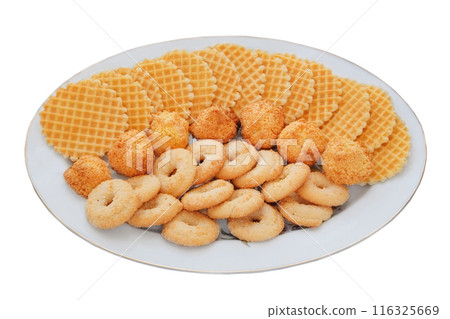 Variety of cakes and waffles in ceramic plate isolated on a white background. Golden romantic biscuit. Top view. 116325669