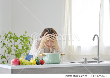 Depressed woman in the kitchen 116325822