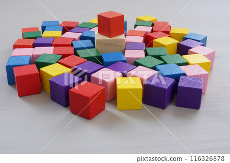 Inclusive leadership. A crowd of multi-colored cubes and one main one. 116326878