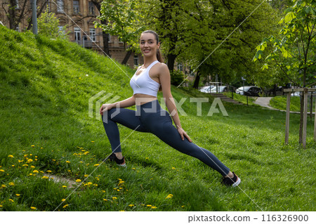Young athlete doing body stretching warming up before workout 116326900