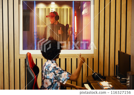 Singer Recording Song With Producer 116327156