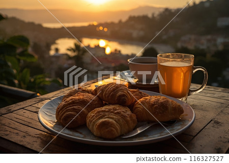 cup of coffee and french croissant on table, balcony with view of beautiful landscape, still life, sea and mountains, resort town, sunset cup of coffee and french croissant on table, balcony with view of beautiful landscape, still life, sea and mountains, resort town, sunset 116327527