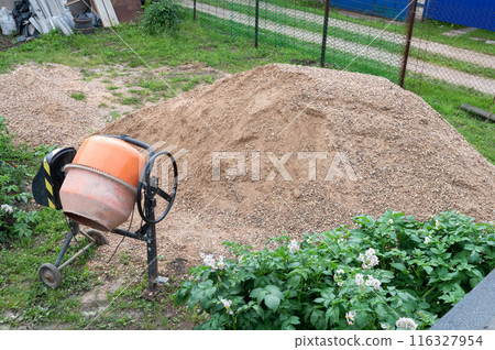 Construction Sand Heap and Cement Mixer at Worksite 116327954