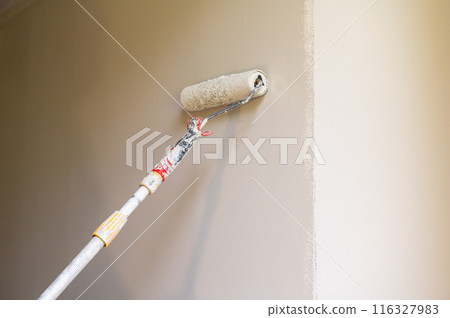 Paint Roller Applying Beige Paint Paint Roller Applying Beige Paint 116327983