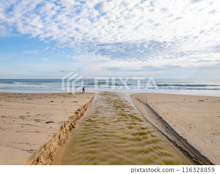 Empty tropical beach and seascape,Amazing sand on beach and blue summer sky background,Aerial view beach for travel background 116328859