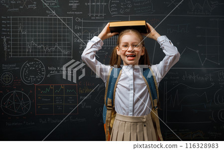 Kid in class on background of blackboard 116328983