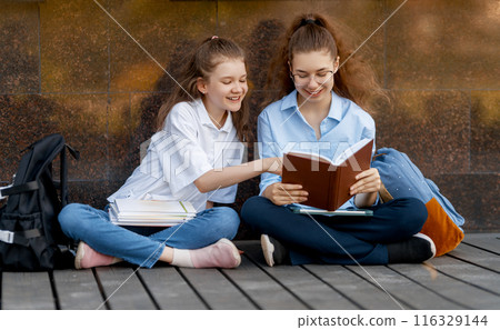 Girls with backpacks outdoors 116329144