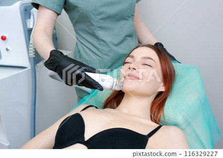 The woman is smiling and she is enjoying the treatment The woman is smiling and she is enjoying the treatment 116329227