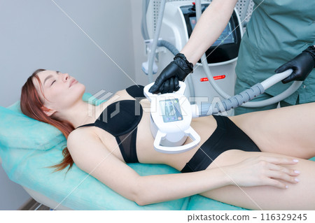 A woman is getting a body contouring treatment A woman is getting a body contouring treatment 116329245