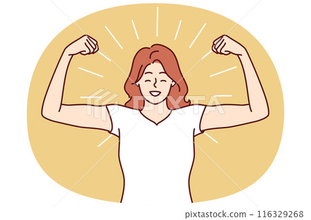 Woman shows biceps and smiles standing in strongman pose to demonstrate self-confidence 116329268
