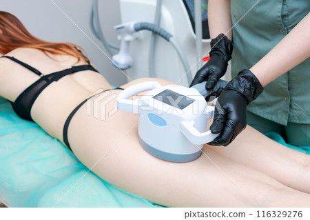 A woman is getting a body contouring treatment A woman is getting a body contouring treatment 116329276