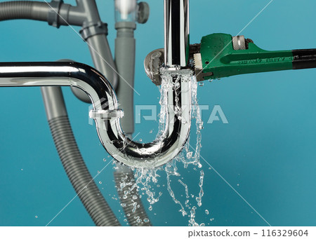 Heavy Duty Wrench fix Water leak under sink. Drain sink leak water from many pipe hose plumbing in bathroom and repair by wrench tools as water splash drop. Blue background isolated 116329604