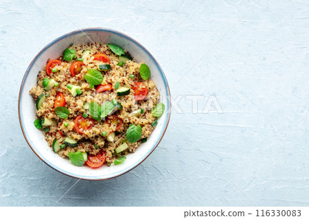 Quinoa tabbouleh salad in a bowl, a healthy dinner with tomatoes and mint Quinoa tabbouleh salad in a bowl, a healthy dinner with tomatoes and mint 116330083