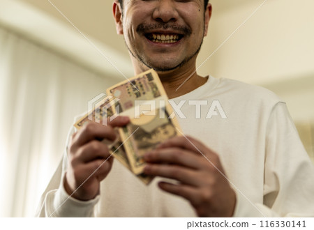 Man holding cash Man holding cash 116330141