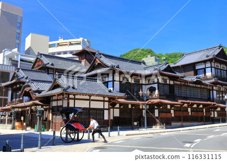 [Ehime Prefecture] Dogo Onsen Main Building and rickshaw on a clear day 116331115