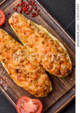Zucchini halves baked with cheese, tomatoes, meat or meat substitute Zucchini halves baked with cheese, tomatoes, meat or meat substitute 116331447