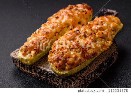 Zucchini halves baked with cheese, tomatoes, meat or meat substitute Zucchini halves baked with cheese, tomatoes, meat or meat substitute 116331578