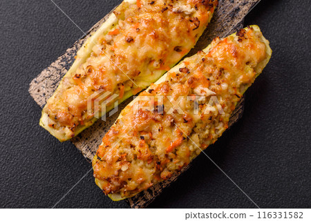 Zucchini halves baked with cheese, tomatoes, meat or meat substitute Zucchini halves baked with cheese, tomatoes, meat or meat substitute 116331582