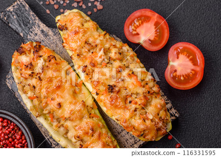 Zucchini halves baked with cheese, tomatoes, meat or meat substitute Zucchini halves baked with cheese, tomatoes, meat or meat substitute 116331595