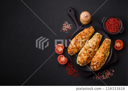 Zucchini halves baked with cheese, tomatoes, meat or meat substitute Zucchini halves baked with cheese, tomatoes, meat or meat substitute 116331616
