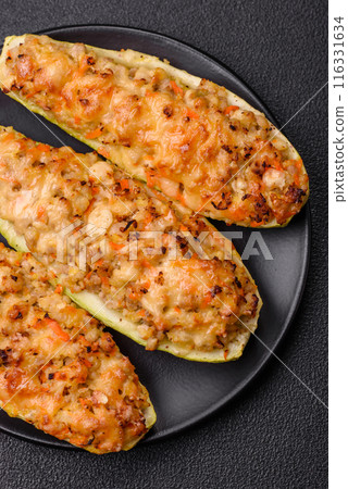 Zucchini halves baked with cheese, tomatoes, meat or meat substitute Zucchini halves baked with cheese, tomatoes, meat or meat substitute 116331634