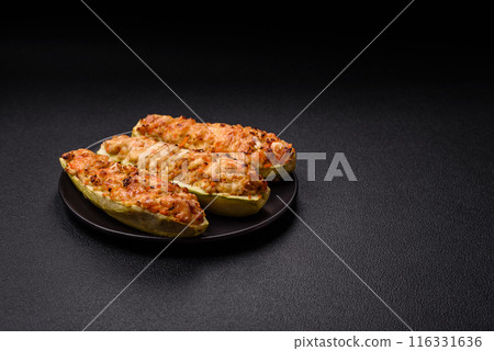 Zucchini halves baked with cheese, tomatoes, meat or meat substitute Zucchini halves baked with cheese, tomatoes, meat or meat substitute 116331636