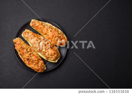 Zucchini halves baked with cheese, tomatoes, meat or meat substitute Zucchini halves baked with cheese, tomatoes, meat or meat substitute 116331638