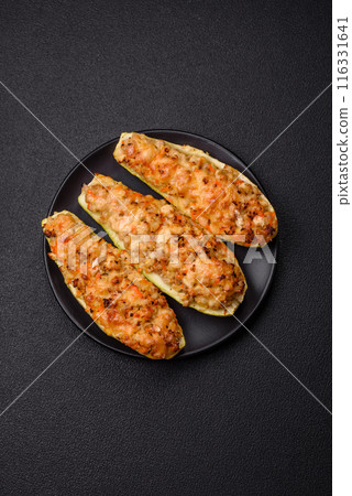Zucchini halves baked with cheese, tomatoes, meat or meat substitute Zucchini halves baked with cheese, tomatoes, meat or meat substitute 116331641