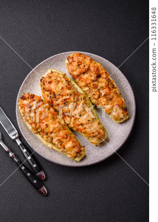 Zucchini halves baked with cheese, tomatoes, meat or meat substitute Zucchini halves baked with cheese, tomatoes, meat or meat substitute 116331648