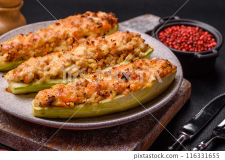 Zucchini halves baked with cheese, tomatoes, meat or meat substitute Zucchini halves baked with cheese, tomatoes, meat or meat substitute 116331655