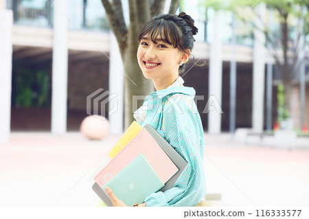 Female college student walking on campus 116333577