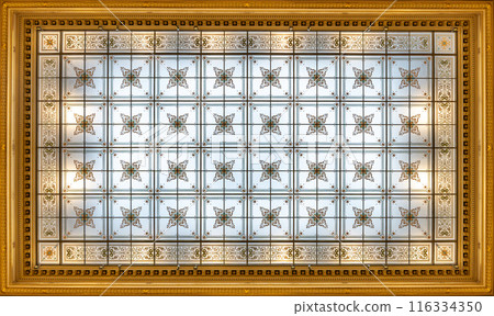 A view of the ornate glass ceiling in the National Museum foyer in Prague. The ceiling is made up of many small glass squares, each with a ornamental pattern. A view of the ornate glass ceiling in the National Museum foyer in Prague. The ceiling is made up of many small glass squares, each with a ornamental pattern. 116334350