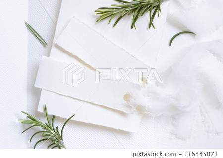 Horizontal Blank cards near white silk ribbons and rosemary leaves top view, wedding mockup Horizontal Blank cards near white silk ribbons and rosemary leaves top view, wedding mockup 116335071