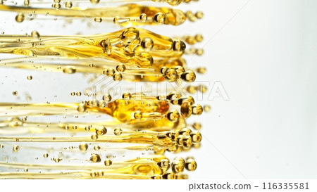 Freeze Motion Shot of Splashing Oil on White Background 116335581