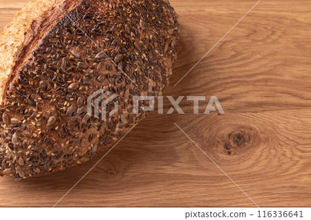 fresh homemade bread on wooden background, top view 116336641