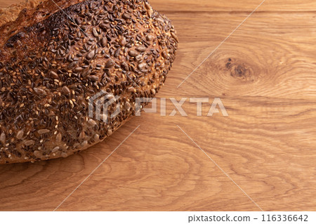 fresh homemade bread on wooden background, side view 116336642