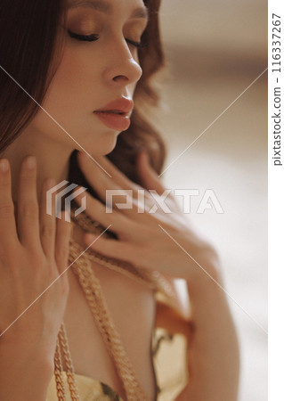 Close-up portrait of a young sexy woman in golden armor Close-up portrait of a young sexy woman in golden armor 116337267