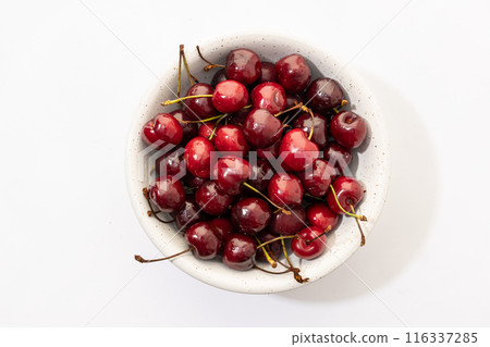 Flat lay of a sweet cherries in bowl isolated on white background Flat lay of a sweet cherries in bowl isolated on white background 116337285