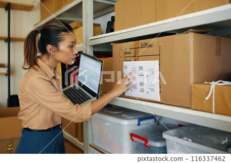 Worker Checking Codes On Box With Online Information 116337462