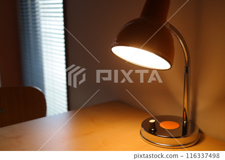 Lamp on a table in a room with window blinds Lamp on a table in a room with window blinds 116337498